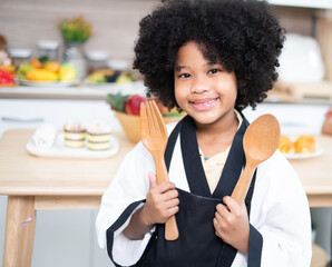 Adorable girls enjoy making baked goods in pastry and bakery class at culinary school.