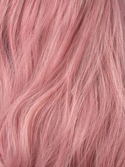Pink hair close-up. Hair texture. Dye hair in bright colors. Hair dye, salon care, home coloring. 