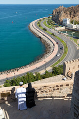 Arab Couple enjoying vista of Muscat Corniche and Harbor from Matrah Fort