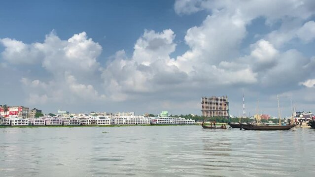 moving shot showing the harbor in Dhaka, Bangladesh, low down close to the water