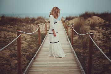 Woman on a pathway to the sea