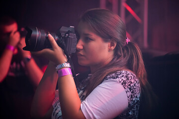 Young female press reporter at a concert