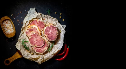 Fotobehang Delicacy sliced beef meatloaf with spiec salt and red pepers on a cutting board and craft paper. Meat delicacies. Top view and copy space on right © vladrad