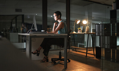 Computer reading, night and African woman review article for social media app, digital website or online blog. serious employee, research thinking and profile journalist working overtime on news post