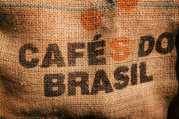 A brown coarse jute sack with a text imprinted ' Cafes do brasil ' which means Coffee from brasil.