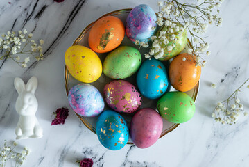 Beautiful multi -colored decorated Easter eggs and a cute white Easter rabbit on a white mromoic background. Close-up