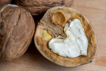 Open and broken walnut shells lying on the table
