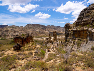 Weathered colorful rocks overgrown with vegetation in N.P Isalo. Madagascar.