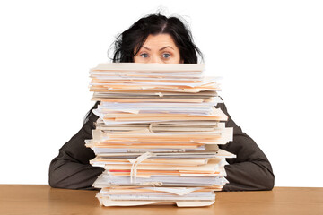 Businesswoman sitting at the table with many papers on background