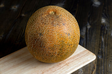 close-up of a part of a ripe whole melon on the table