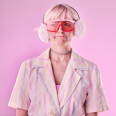Fashion, gen z and woman in a studio with trendy glasses, earmuffs and outfit with style. Edgy,...