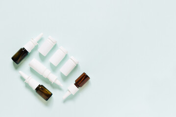 Set of different white and brown medicine bottles, pill bottles without label design,  copy space on blue background	