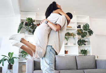 Young couple, hug and jump in new house, real estate and apartment lounge with love. Happy homeowners hugging to celebrate in living room, property investment and dance with care, energy or happiness