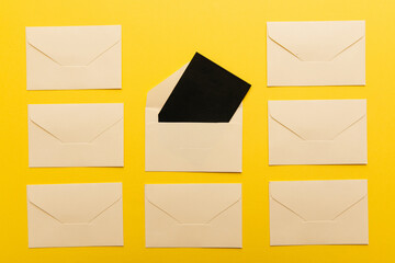 Light envelopes with card inside isolated on yellow background