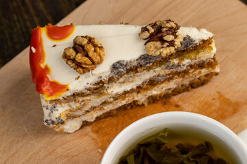 a cut piece of multi-layered honey cake with creamy filling