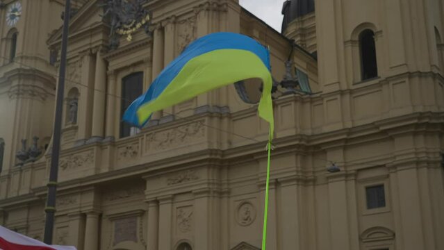 Munich. Germany. Odeonsplatz muenchen. Subject of war between Russia and Ukraine. Protesters holding yellow and blue and European Union flags at demonstration against war in Bayern. 