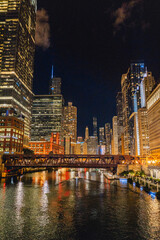 Fototapeta na wymiar Chicago lights at night, skyline of city view from bridge on summer evening