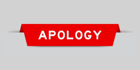 Red color inserted label with word apology on gray background