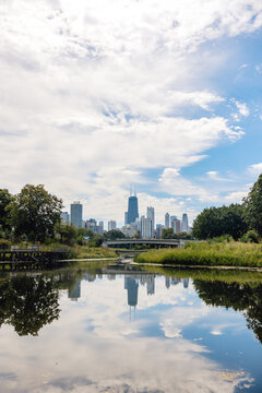 Chicago Downtown Skyline Taken From Lincoln Park With Reflections In Lake On Sunny Cloudy Day In Summer 