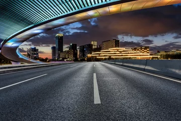 Stoff pro Meter Asphalt road and bridge with modern city skyline at night in Ningbo, Zhejiang Province, China. © ABCDstock