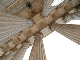 Upward view of the US Supreme Court columns with cut out sky.