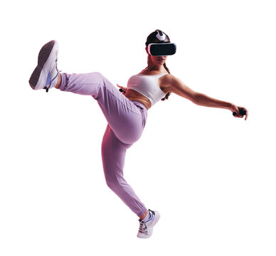 Active young woman throwing a kick in a vr game against a transparent background