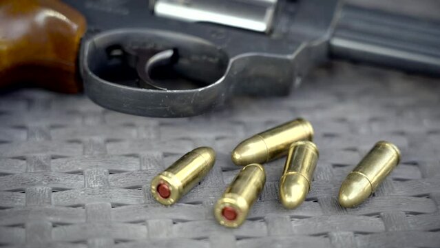 Close up view of bullets and handguns. Shallow depth of field.
