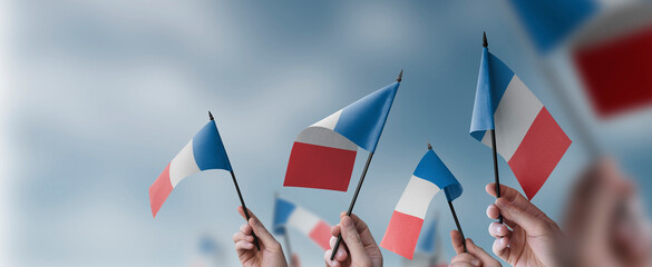 A group of people holding small flags of the France in their hands