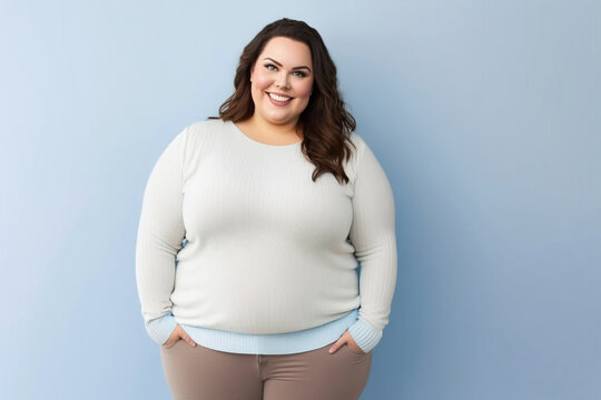 smiling curvy woman looking at camera, standing against blue background. Created by generative AI