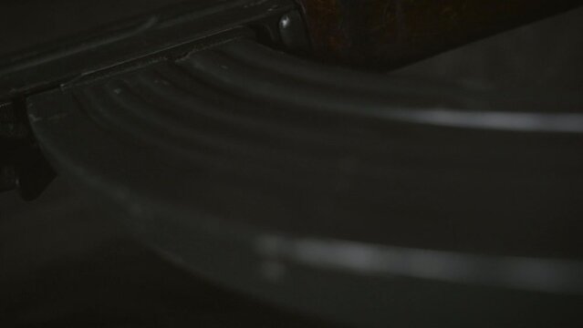 Low key photo of AK-47 Kalashnikov rifle. Dark themed automatic rifle from Russia/Soviet union.	