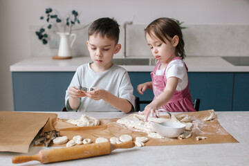 Lifestyle photo of cooking Easter decor. Family time. Under celebrated moment. Brother and little sister activity together. 