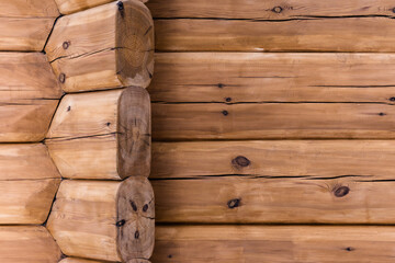 Rural house wall made of calibrated logs, background texture