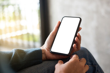 cell phone blank white screen mockup.hand holding texting using mobile on desk at office.background empty space for advertise.work people contact marketing business,technology