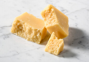 pieces of parmesan on white marble surface