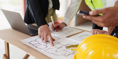 Civil Construction team working at renovate construction site. architectural plan, engineer sketching a construction project, green energy concept.