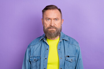 Portrait of focused concentrated nice aged person look camera isolated on pastel purple color background