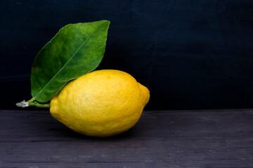 Lemon fruit.Lemon fruit with leaf isolated. Whole lemons on a wooden table