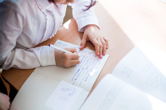 Children's hands with ballpoint pen while writing