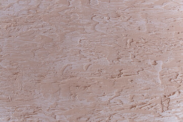Peach abstract background. Decorative plaster.Coarse surface texture. Wall decoration