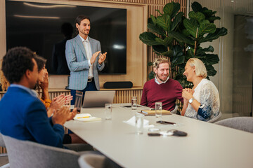 Team congratulates their female leader on success.