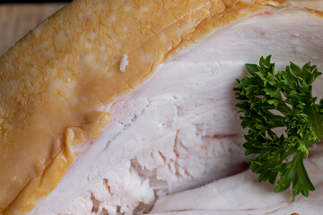 Smoke-smoked chicken is cut up on a board