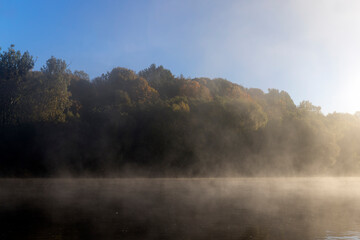 Fog-covered river in the autumn season