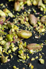Scattered pistachios of green color with salty taste