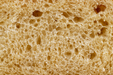 A cut loaf of round-shaped wheat bread