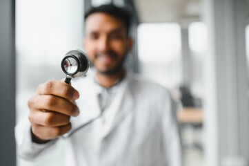 Indian doctor holding stethoscope at clinics