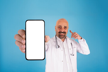 Showing smartphone, caucasian doctor showing smartphone. Gesturing call me, posing, isolated on...