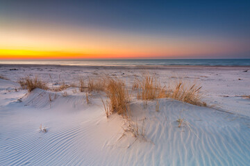 Fototapeta na wymiar Beautiful scenery of the Baltic Sea beach at sunset, Slowinski National Park, Leba. Poland