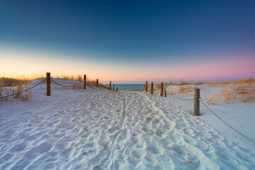 Beautiful scenery of the Baltic Sea beach at sunset, Slowinski National Park, Leba. Poland - obrazy, fototapety, plakaty