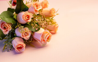 Bouquet of pink roses on pink background, copy space 