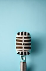 Fototapeta na wymiar Retro style microphone on light blue background. Generative AI.